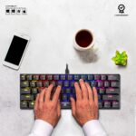 "User's hands on the Ant Esports MK1200 Mini Keyboard, demonstrating the ergonomic design and typing comfort."