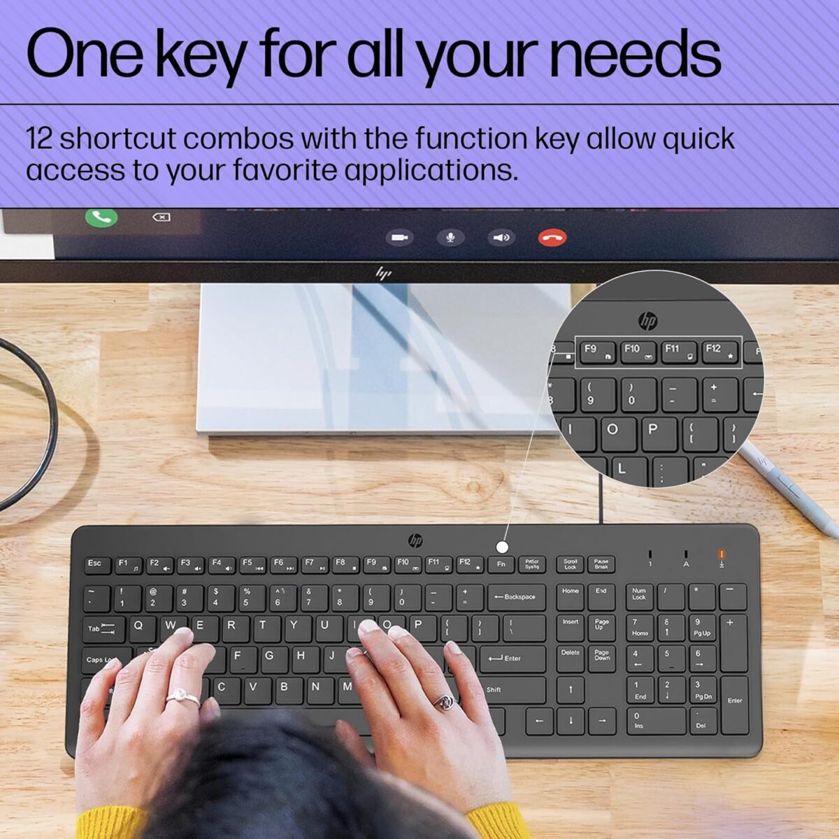 "HP 150 Wired Keyboard in a desktop setup, demonstrating its ergonomic design, full-size layout, and user-friendly shortcut keys for efficient workflow."